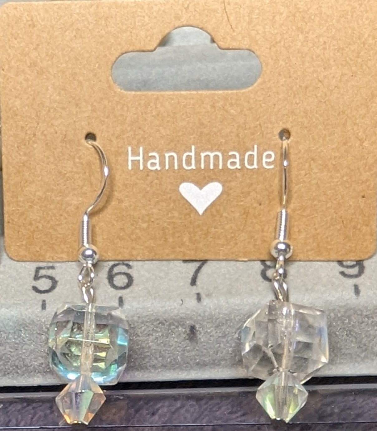Crystal iridescent dangle earrings on sterling silver hoops.
