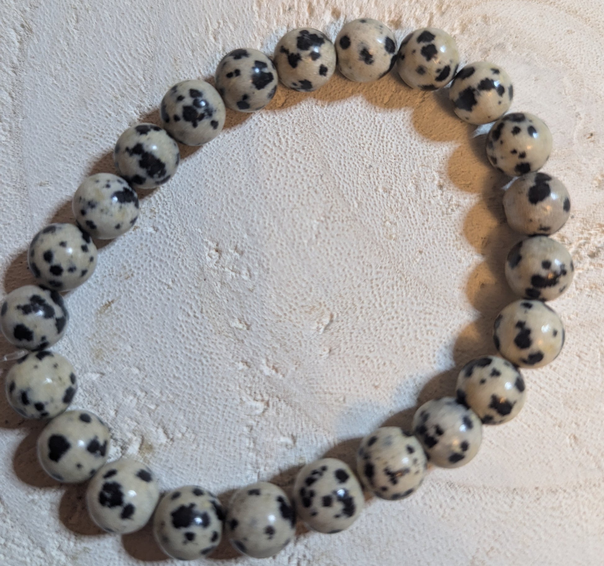 Bracelet made of white beads with black spots 