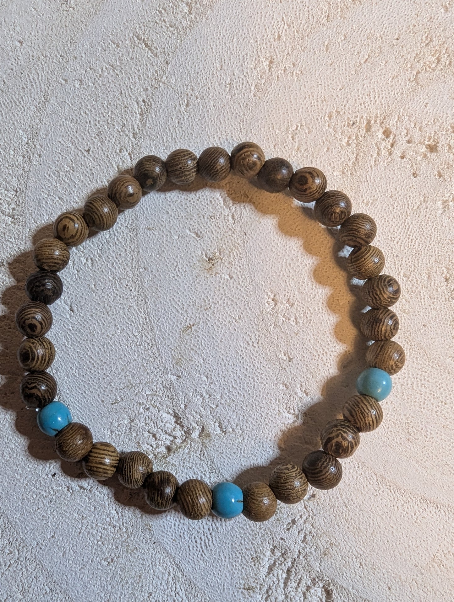 Wooden beaded bracelet with blue accents 
