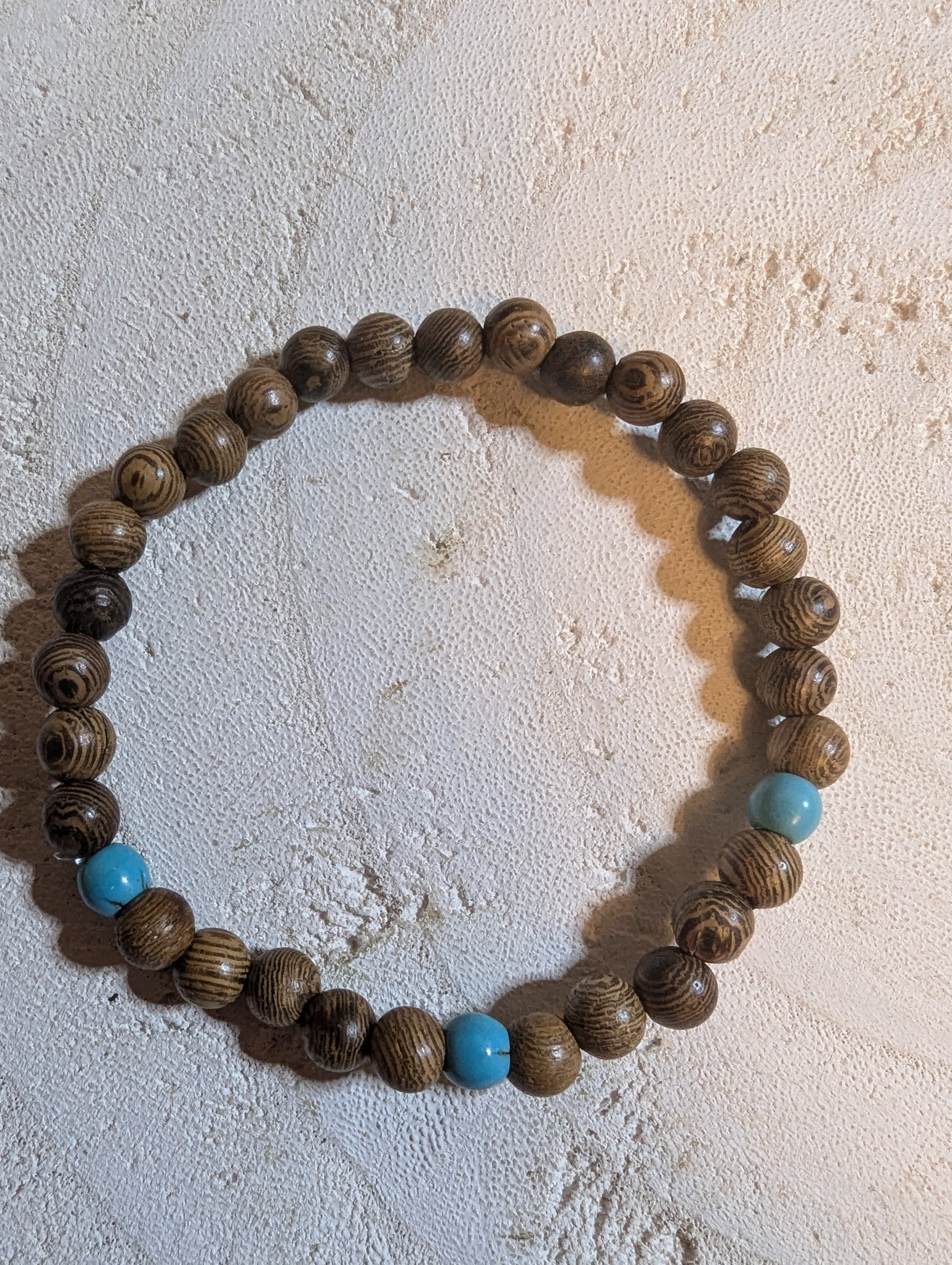 Wooden beaded bracelet with blue accents 