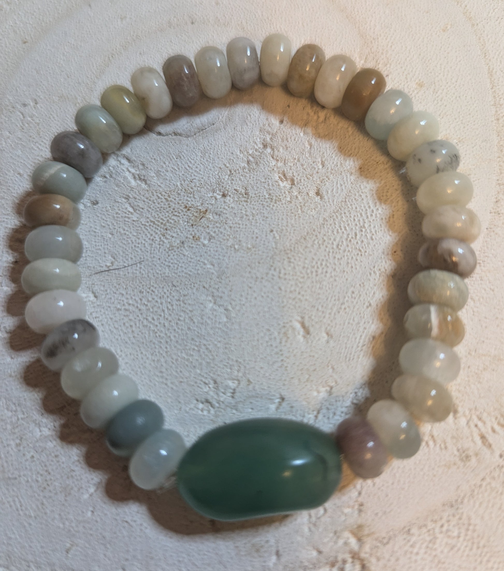 Beaded bracelet with a large green stone