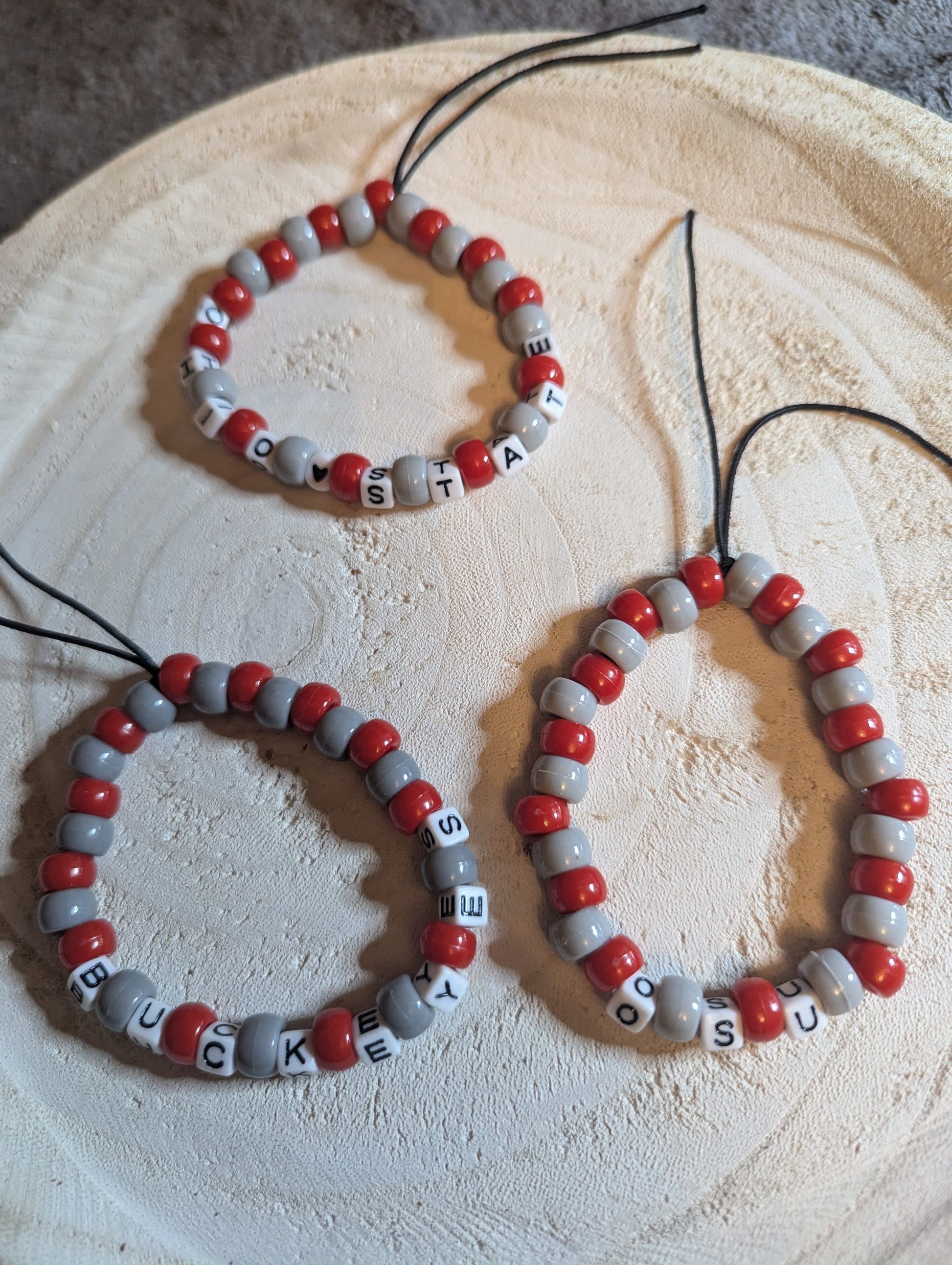 Beaded bracelets with red and gray beads that are adjustable  Pick hitch one you like, or all 3. 