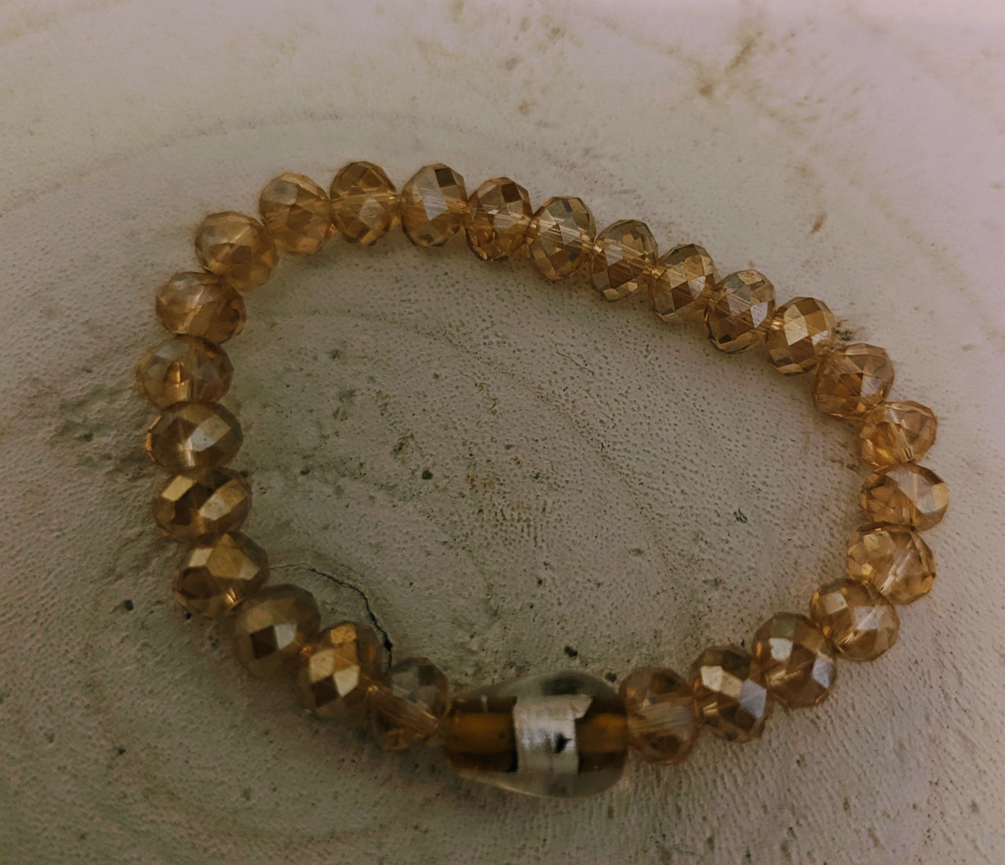 Beaded bracelet with amber-colored beads 