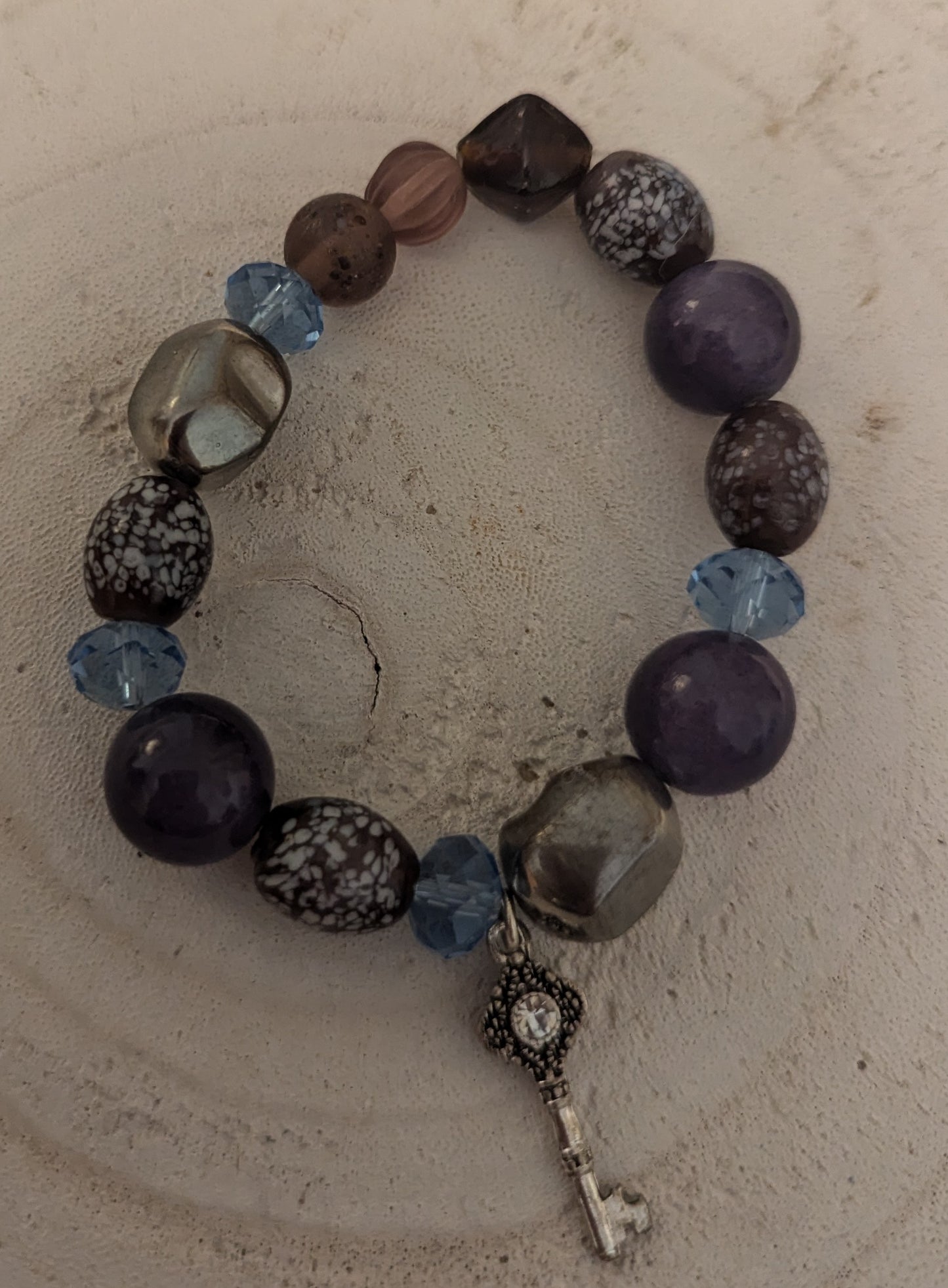 Beaded bracelet with a key charm