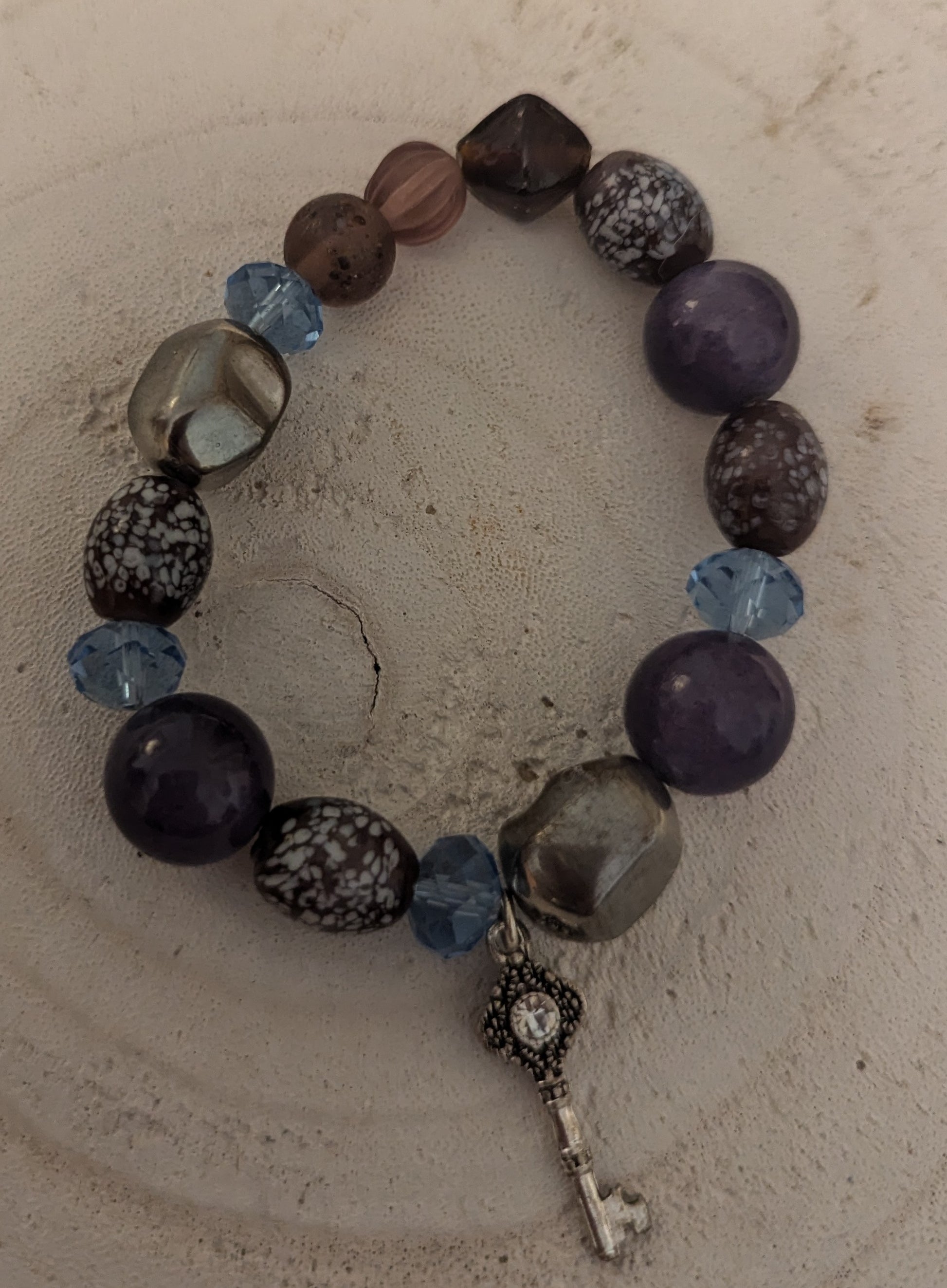 Beaded bracelet with a key charm