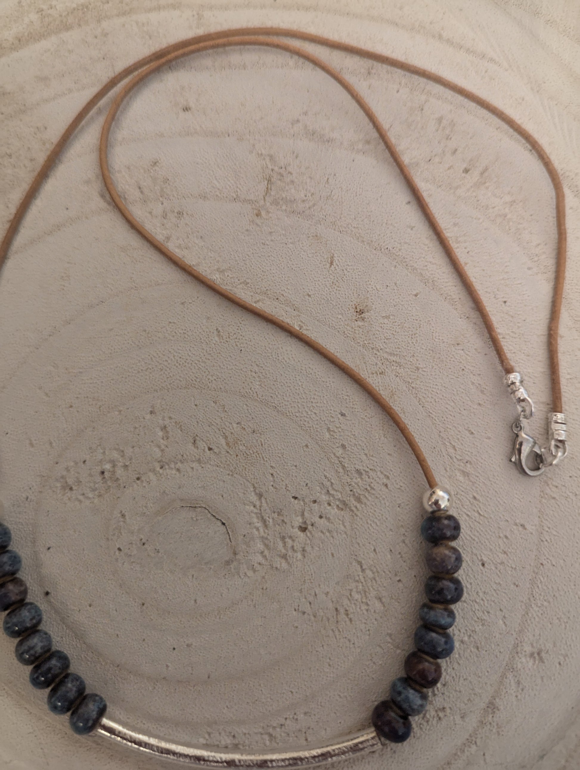 Necklace with dark beads and a .925 sterling silver bar