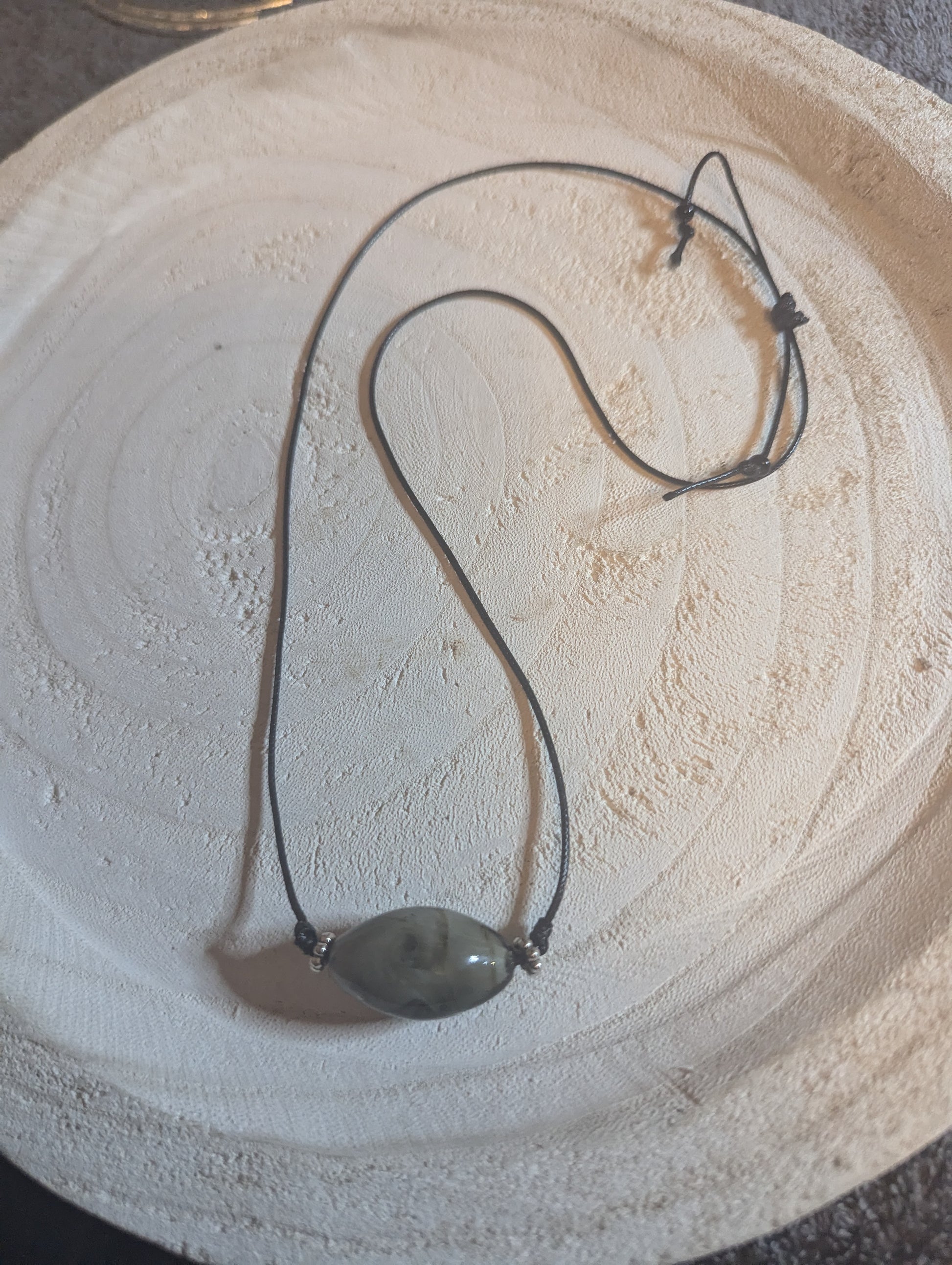 Adjustable necklace with a stone pendant 