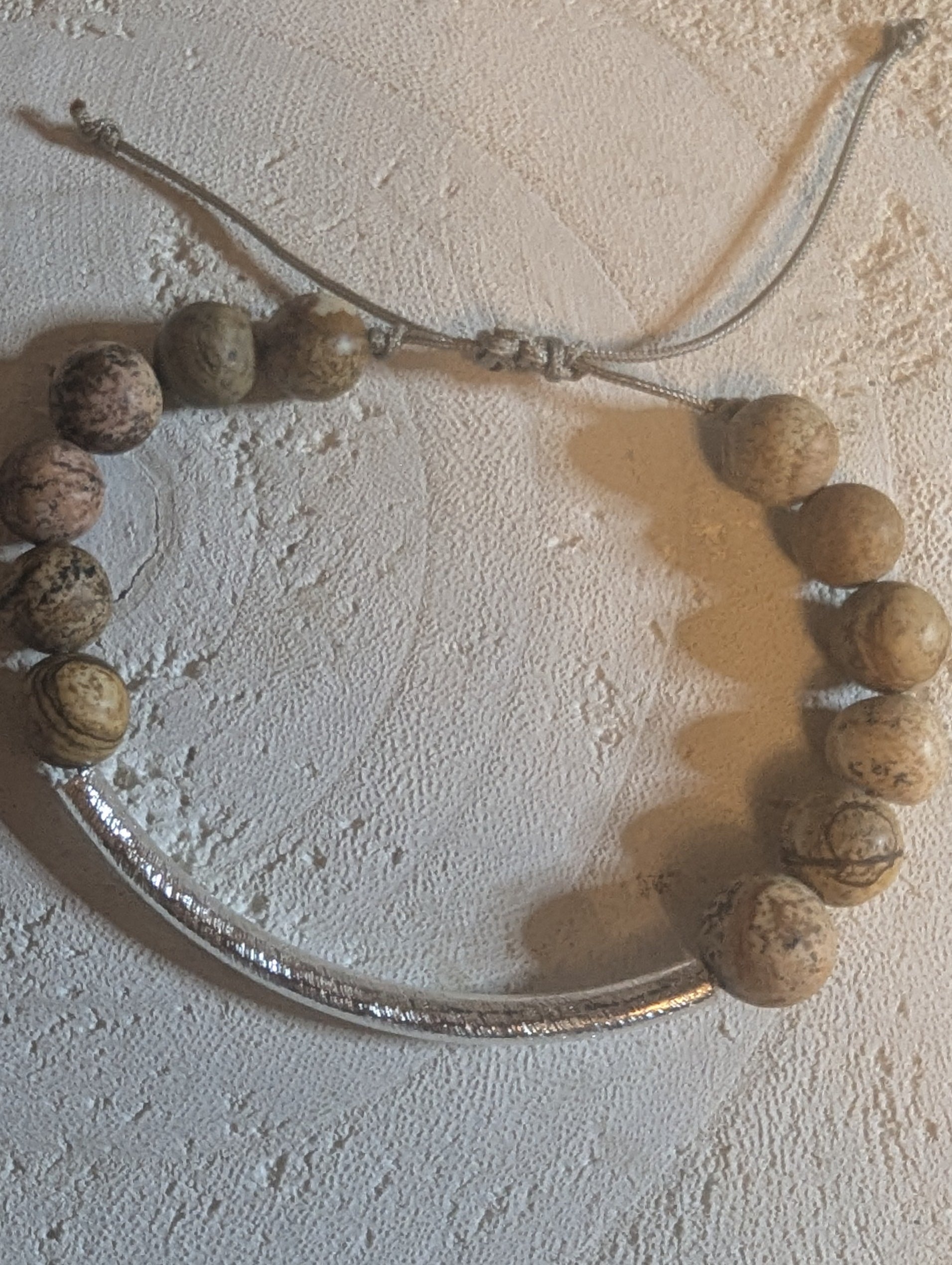 Adjustable bracelet with round wooden  beads and a .925 sterling silver tubing