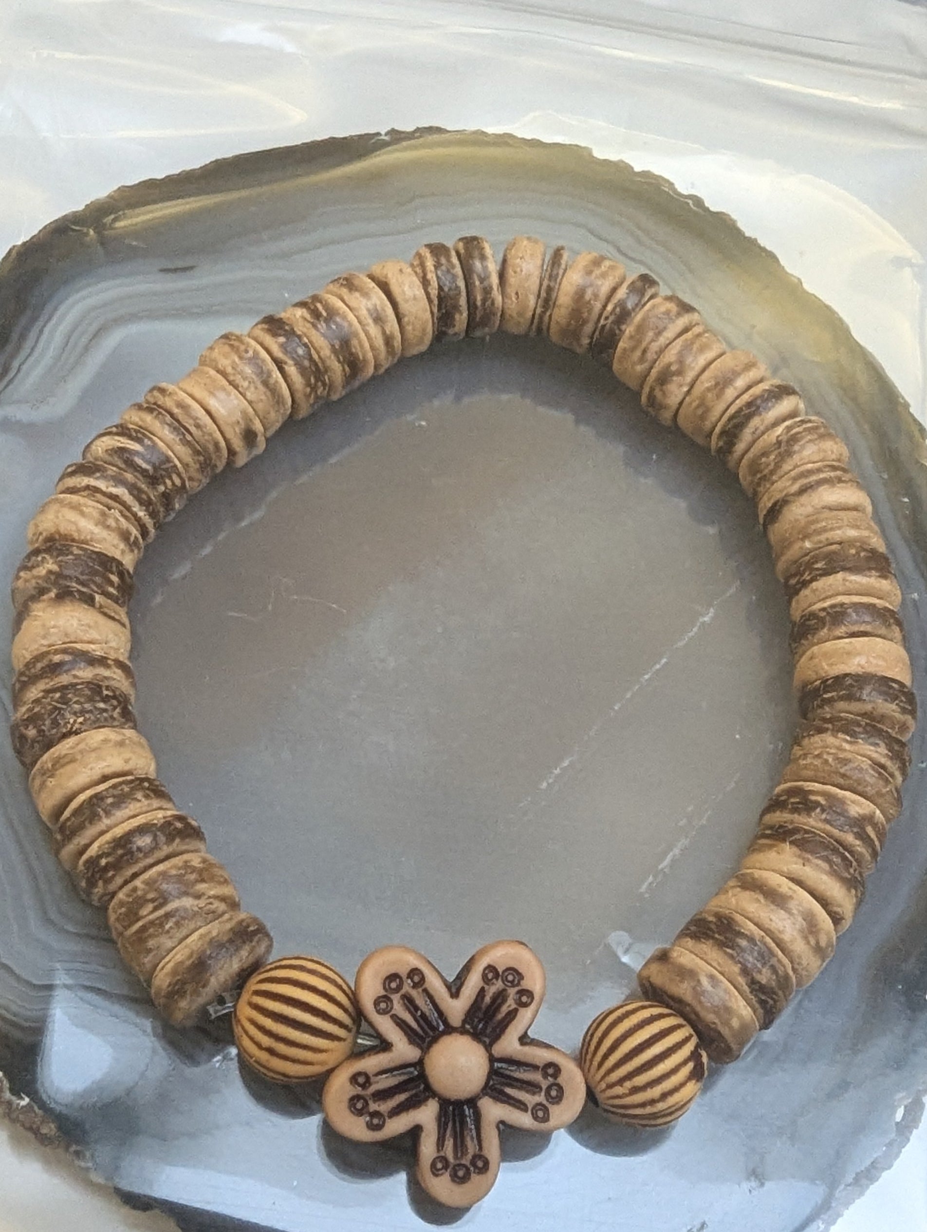 Wooden bracelet with a flower charm 