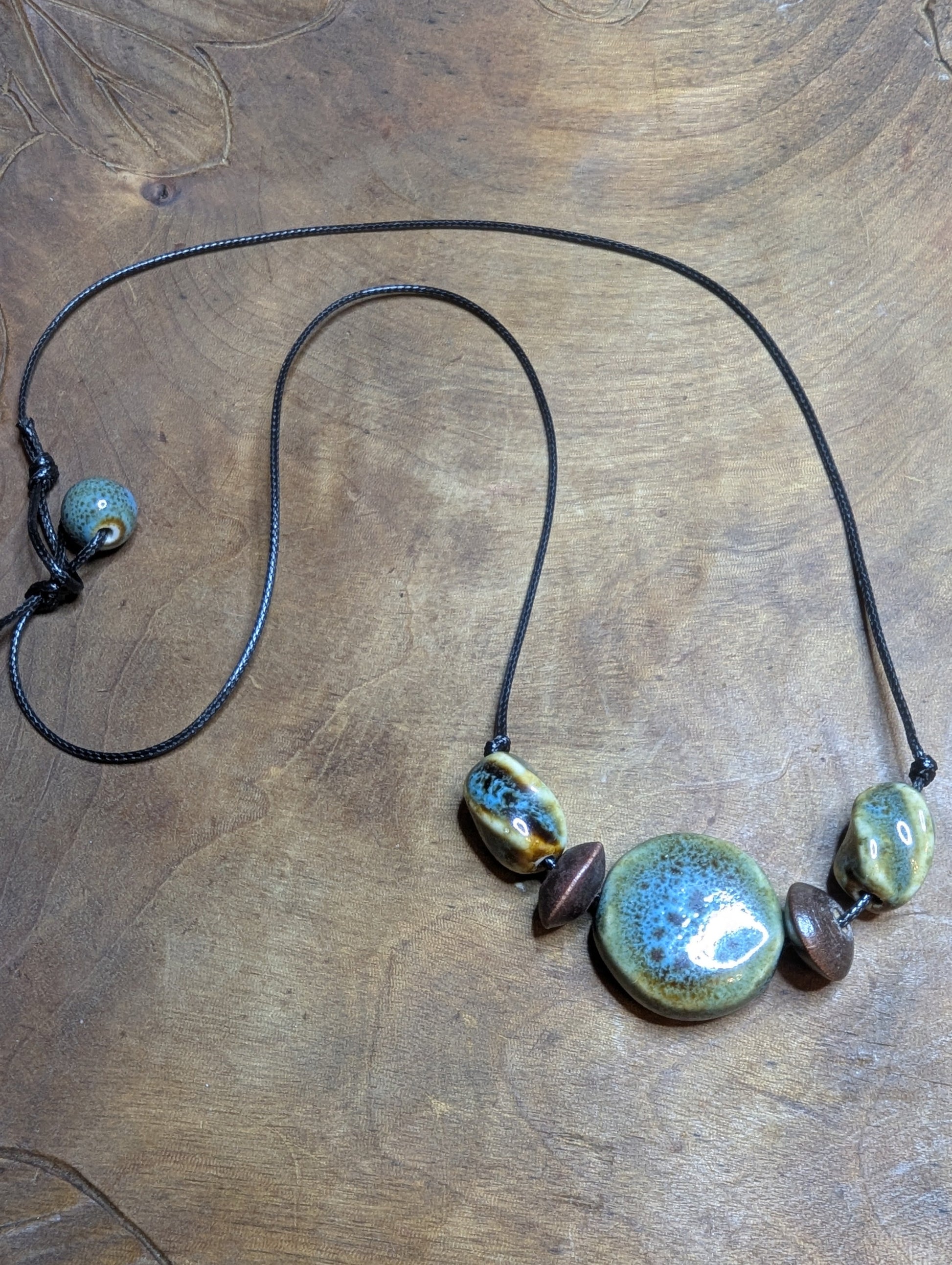 Necklace with ceramic beads from Sedona, AZ on a leather cord.
