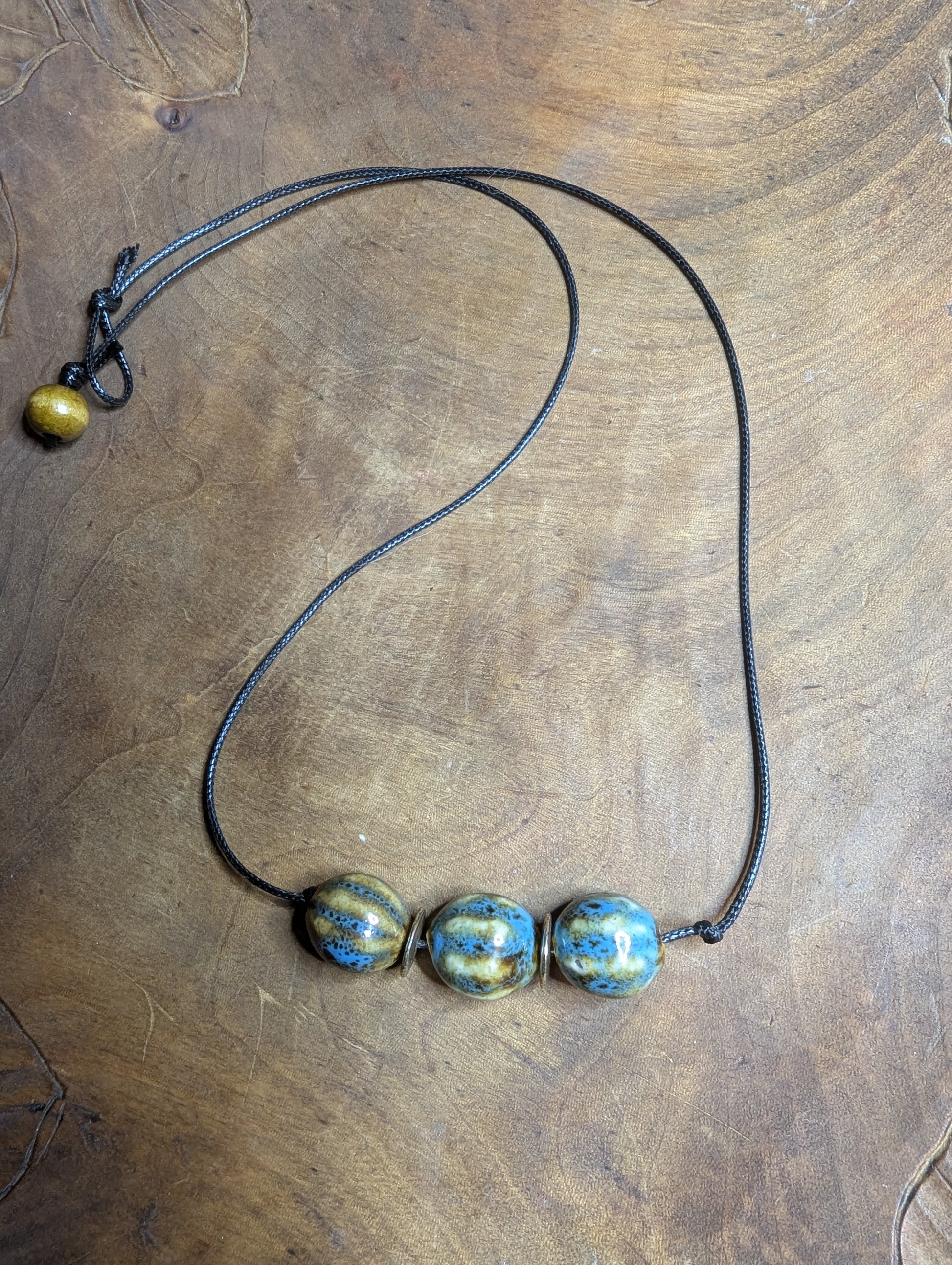 Necklace with three blue and gold beads from Sedona, AZ