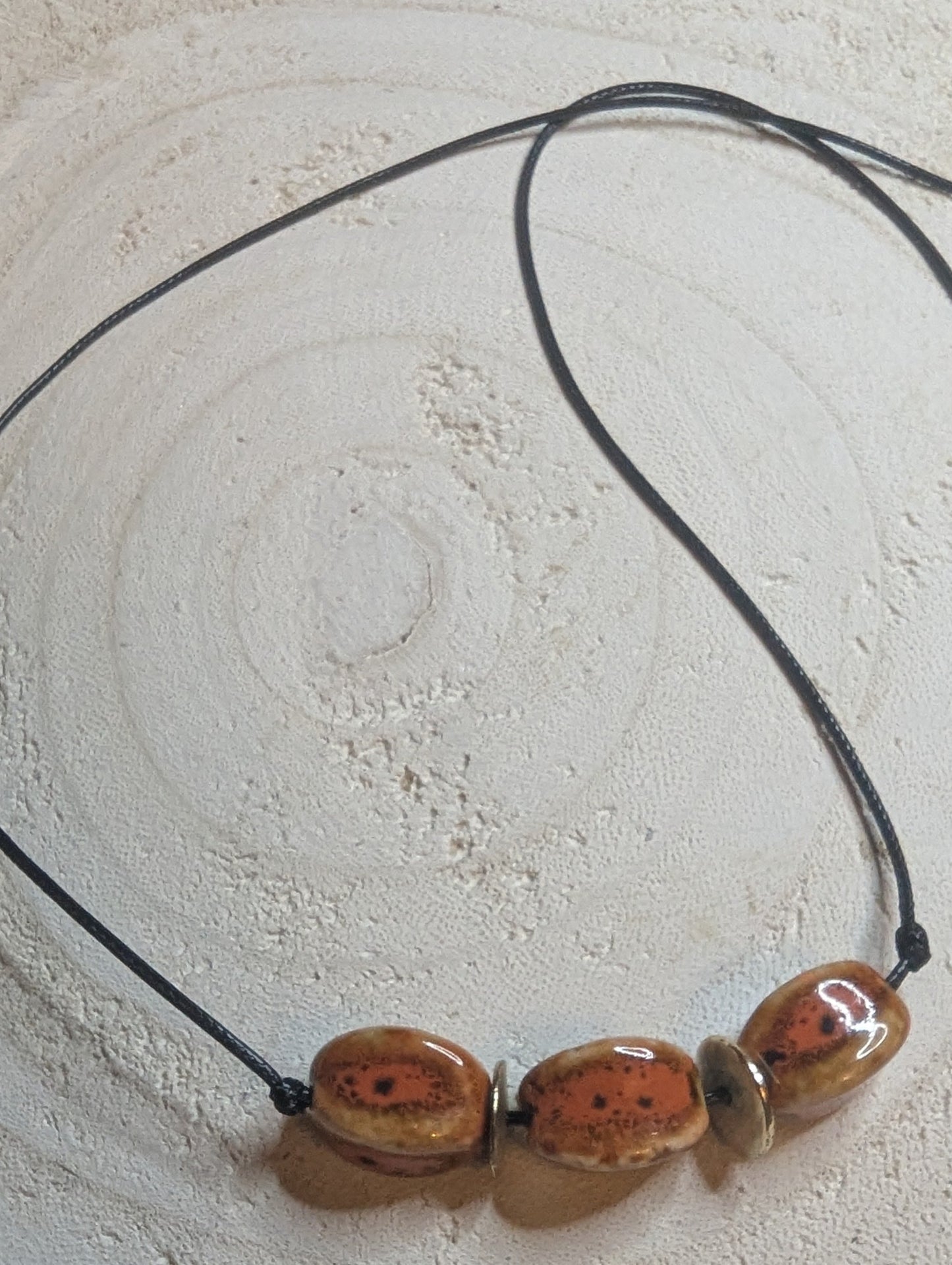 Necklace with three brownish red stone beads directly from Sedona Arizona on a leather cord.  Adjustable 