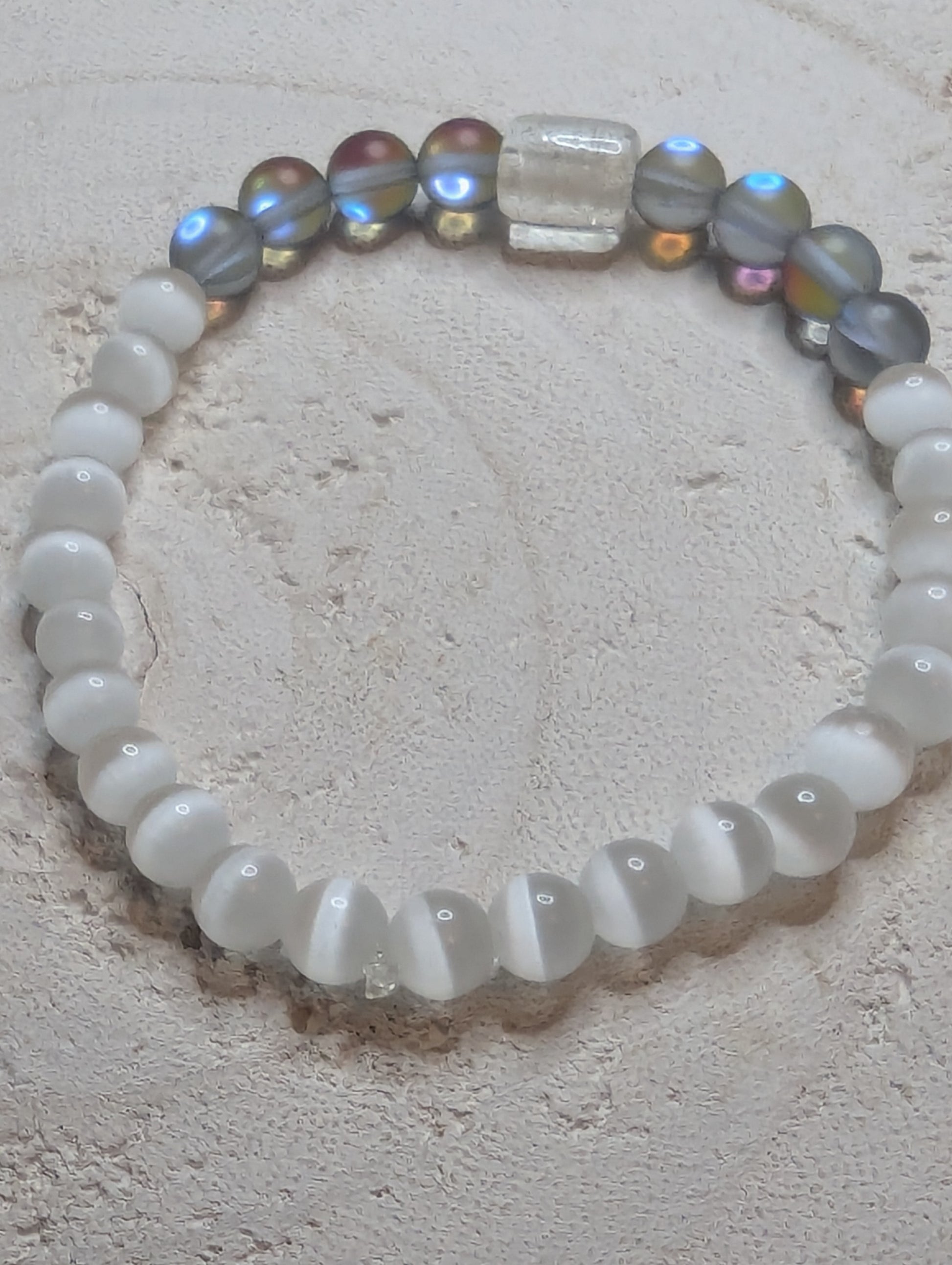 Beaded bracelet with white, multicolored, and clear beads 
