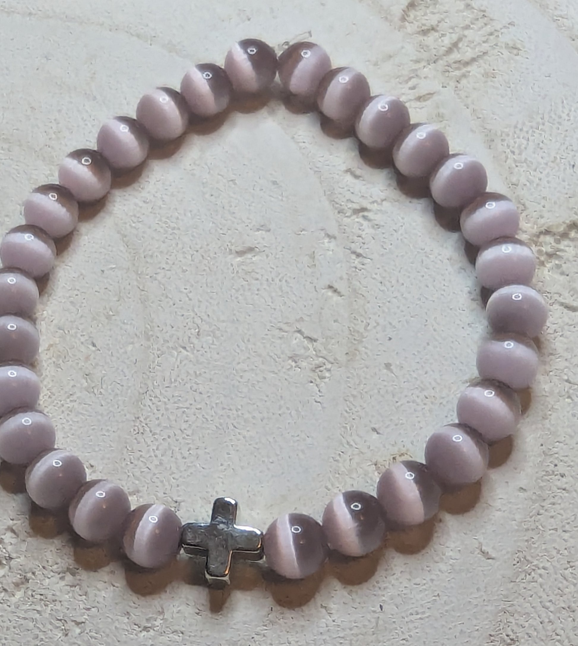 Beaded bracelet with a cross charm