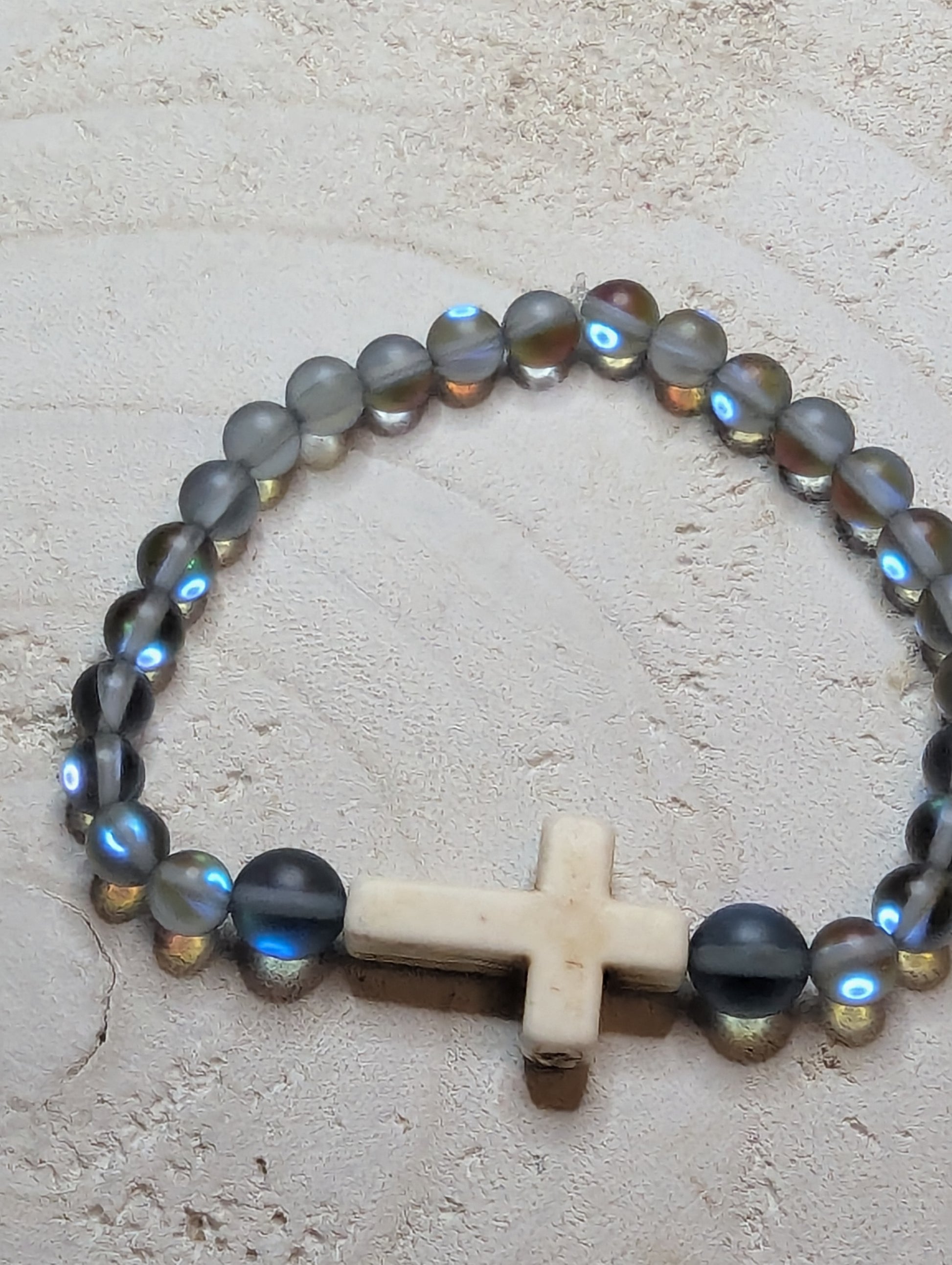 Beaded bracelet with a cross charm 