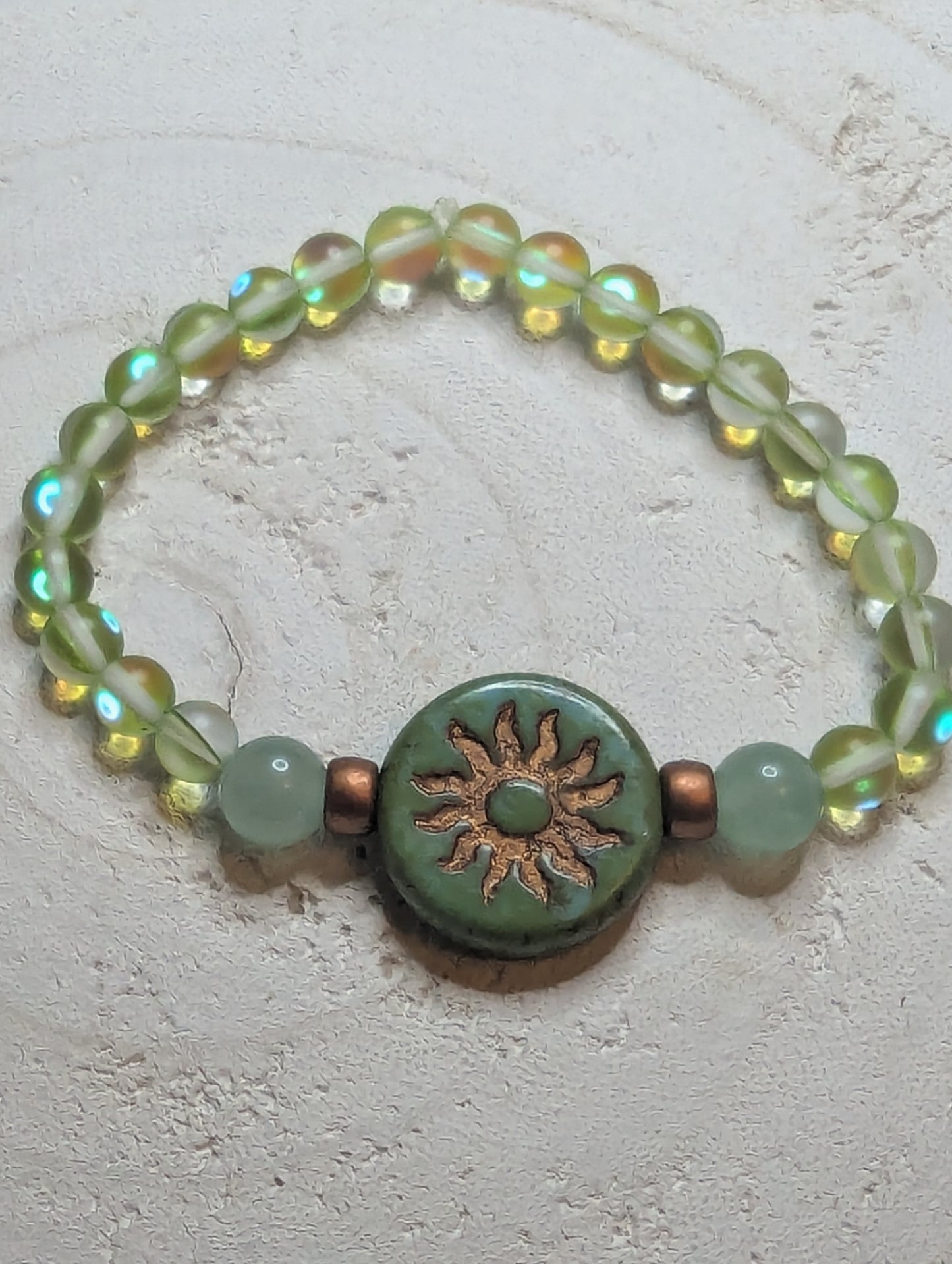 Beaded bracelet with a sun design charm