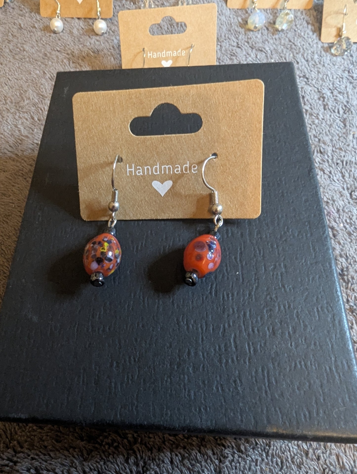 Sterling silver hoop earrings with red ceramic beads