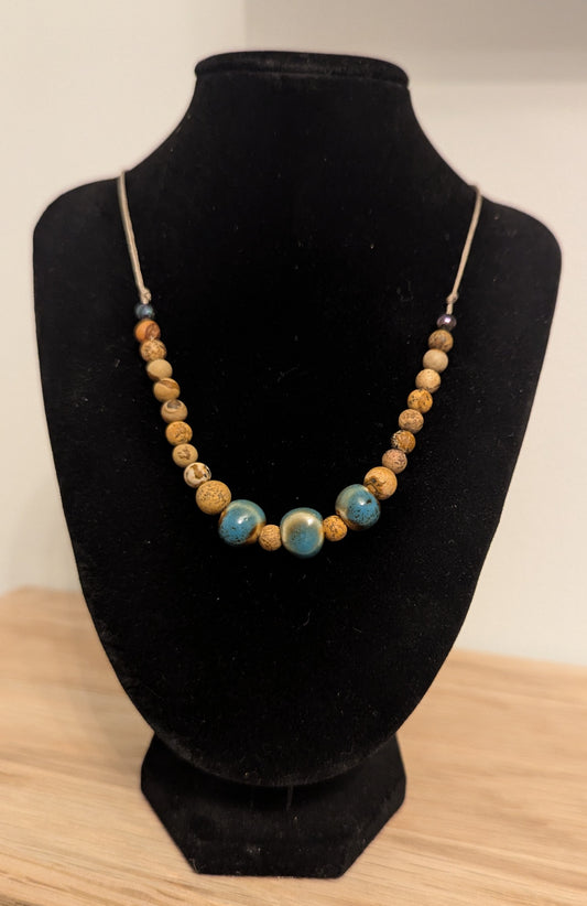 Louii collection. Necklace with blue ceramic stones surrounded by wooden beads.